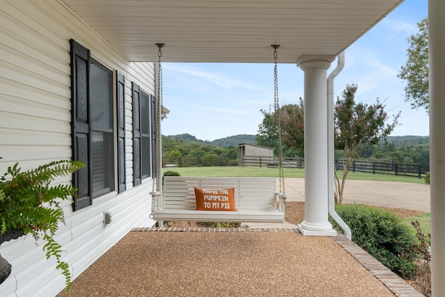 view of patio featuring a mountain view and a porch