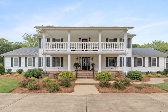 view of front of home with a porch and a balcony