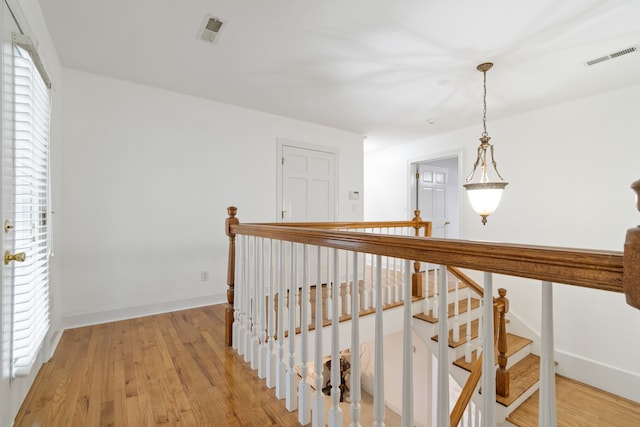 corridor with light hardwood / wood-style floors