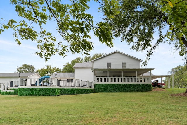 back of house with a lawn