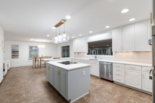 kitchen featuring white cabinets, dishwasher, sink, and hanging light fixtures