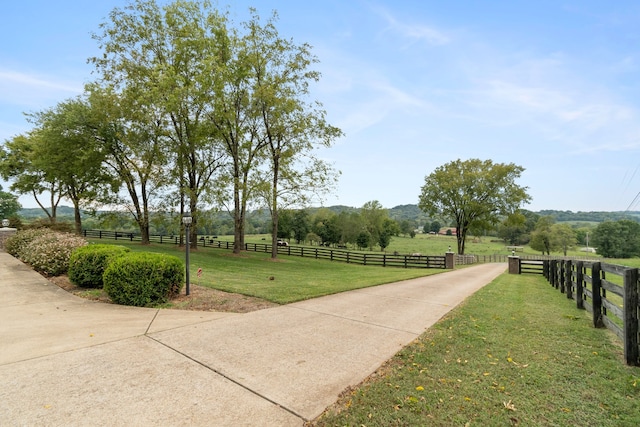 surrounding community featuring a yard and a rural view