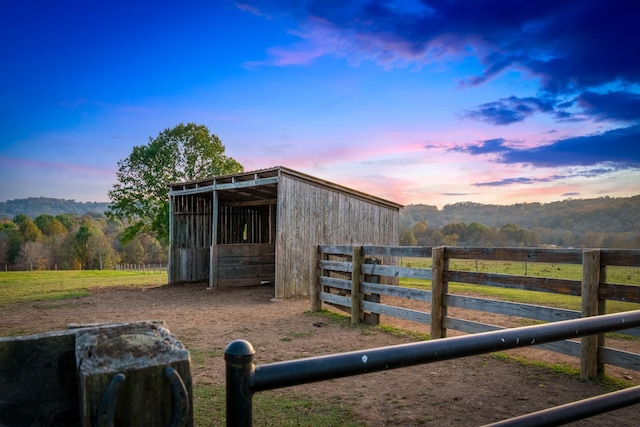 view of stable with a mountain view and a rural view