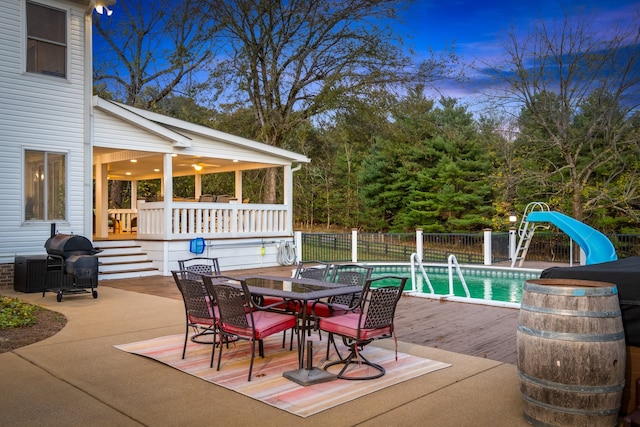 exterior space with a grill, a fenced in pool, and a patio area