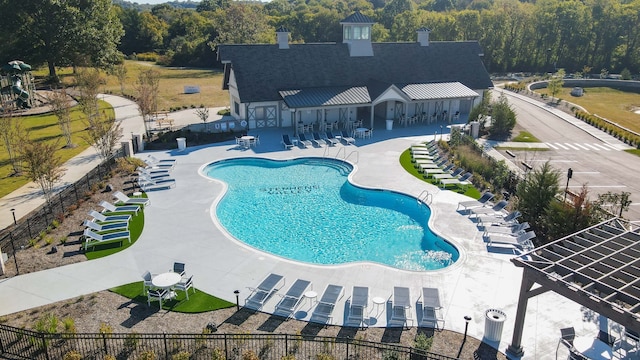 view of pool with cooling unit and a patio