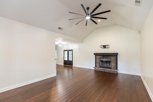 unfurnished living room with dark wood-type flooring, a fireplace, lofted ceiling, ceiling fan, and french doors