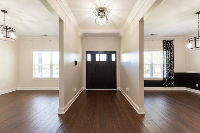 foyer with plenty of natural light, dark hardwood / wood-style flooring, and crown molding