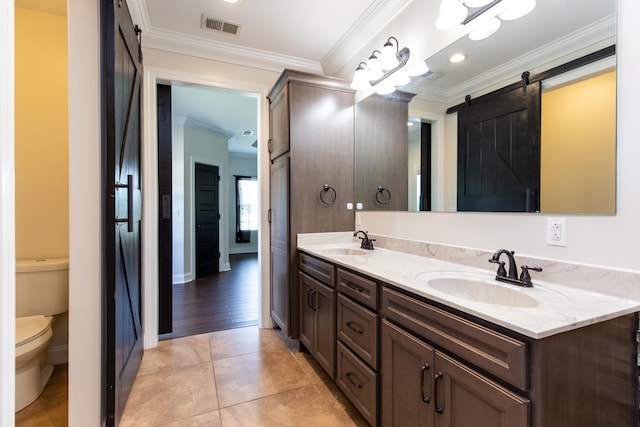 bathroom with hardwood / wood-style floors, crown molding, toilet, and vanity