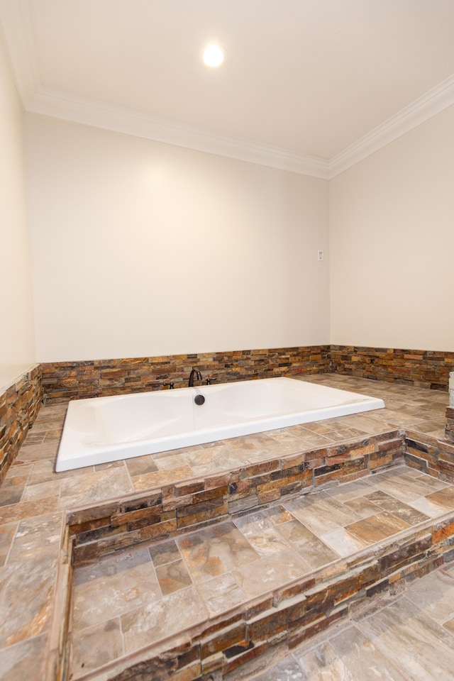 bathroom with tiled tub and crown molding