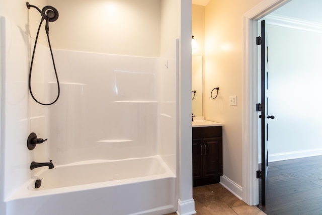 bathroom featuring wood-type flooring, vanity, and bathtub / shower combination