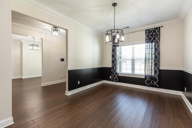 spare room with an inviting chandelier, ornamental molding, and dark hardwood / wood-style floors