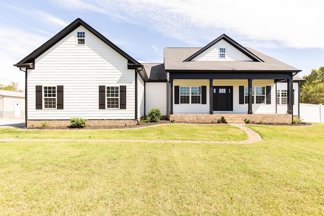 view of front facade with covered porch and a front yard