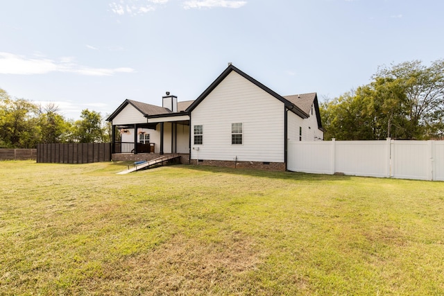 back of property with a lawn