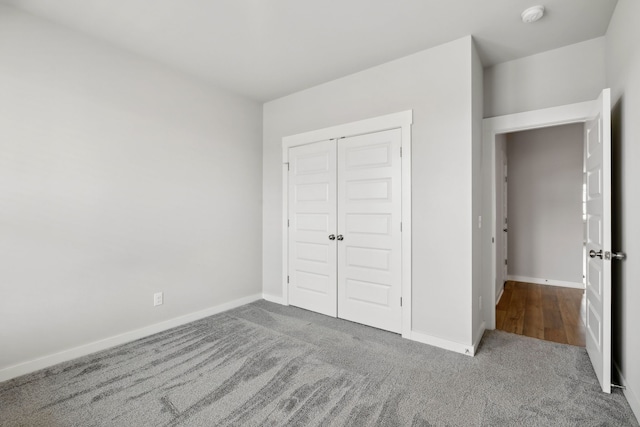 unfurnished bedroom featuring a closet and carpet floors