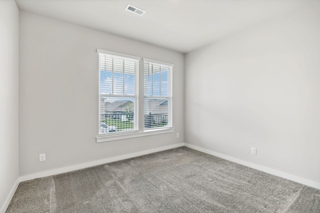 carpeted empty room with plenty of natural light