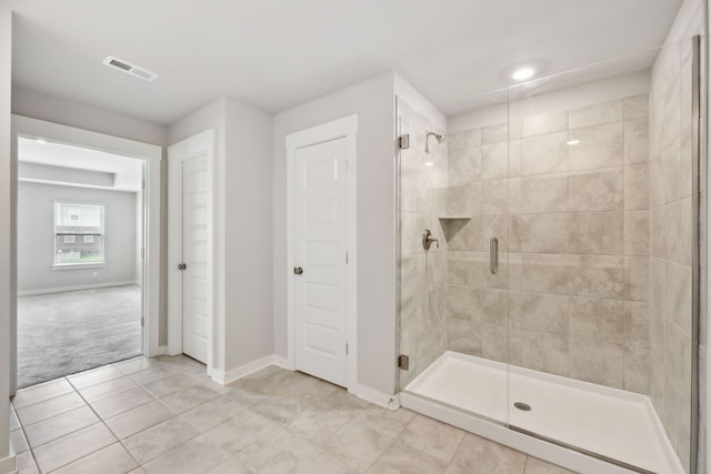 bathroom featuring tile patterned floors and an enclosed shower