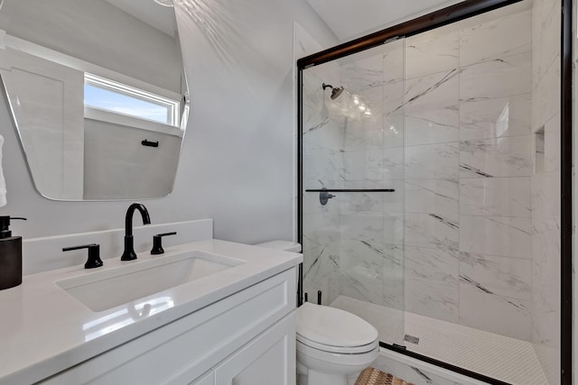 bathroom featuring vanity, toilet, and a stall shower