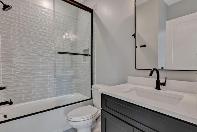full bathroom with combined bath / shower with glass door, toilet, and vanity