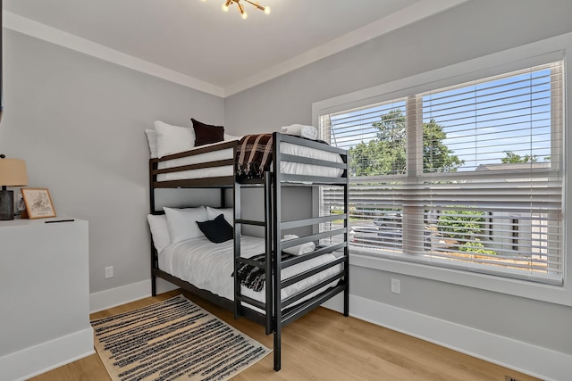 bedroom with light wood-style flooring and baseboards