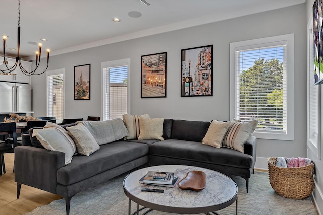 living room featuring baseboards, recessed lighting, and a notable chandelier
