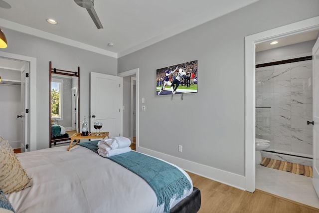 bedroom featuring light wood finished floors, ensuite bathroom, baseboards, and recessed lighting
