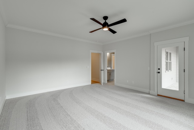 spare room featuring light carpet, crown molding, and ceiling fan