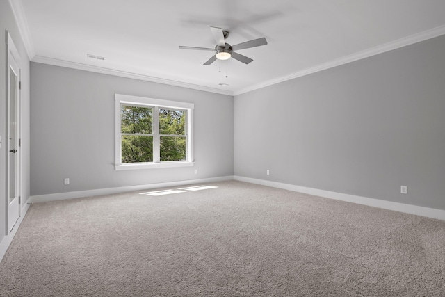 empty room with crown molding, carpet flooring, and ceiling fan