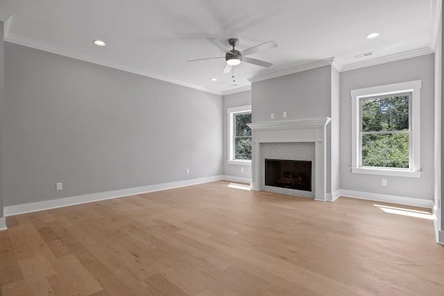 unfurnished living room featuring ceiling fan, crown molding, and light hardwood / wood-style floors