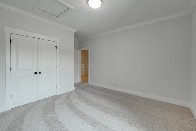 unfurnished bedroom featuring a closet, crown molding, and carpet flooring