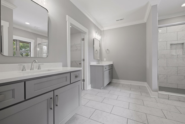 bathroom with ornamental molding, tiled shower, and vanity