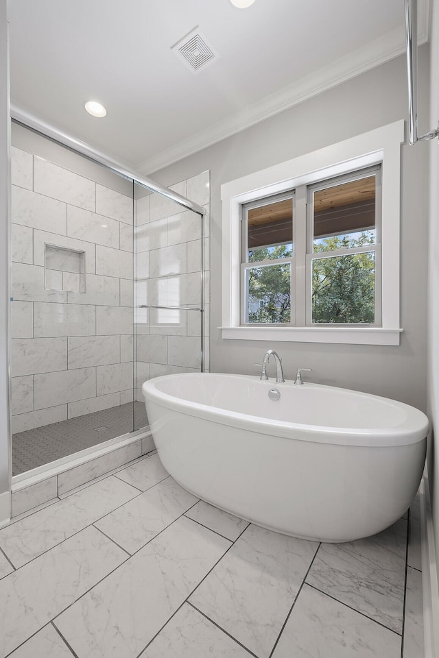 bathroom featuring separate shower and tub and crown molding