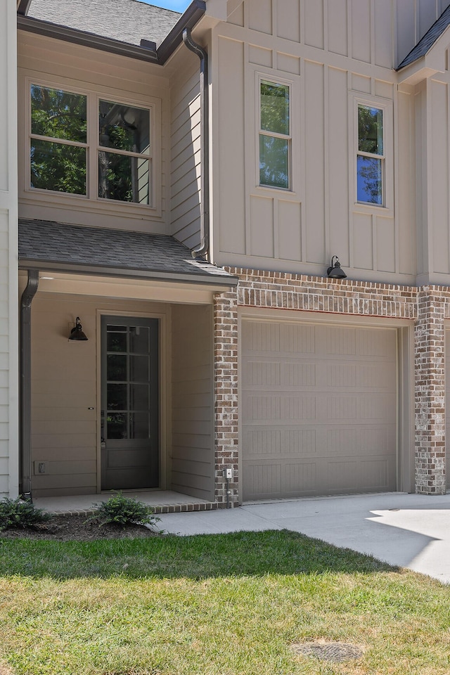 view of front of house with a garage and a front lawn