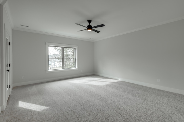 carpeted empty room with crown molding and ceiling fan