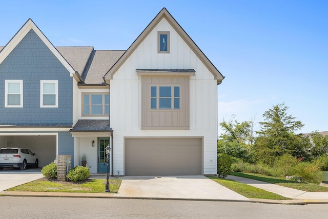 multi unit property with an attached garage, driveway, board and batten siding, and a shingled roof
