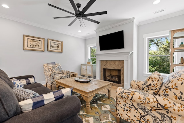 living room with ceiling fan, a fireplace, hardwood / wood-style floors, and ornamental molding