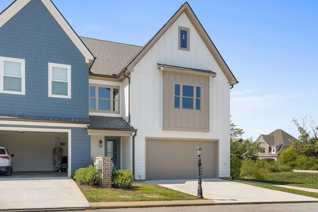 view of front of property featuring a shingled roof, central AC, board and batten siding, an attached garage, and driveway