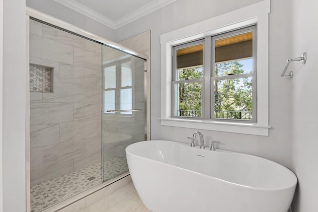bathroom with ornamental molding, a soaking tub, and a stall shower