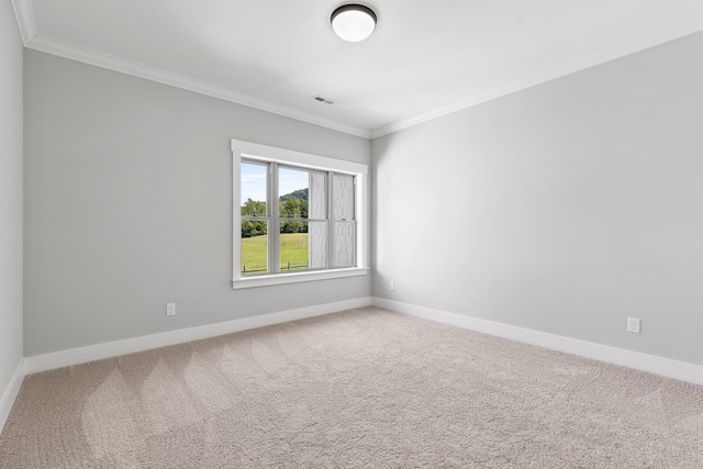 carpeted spare room featuring baseboards, crown molding, and visible vents