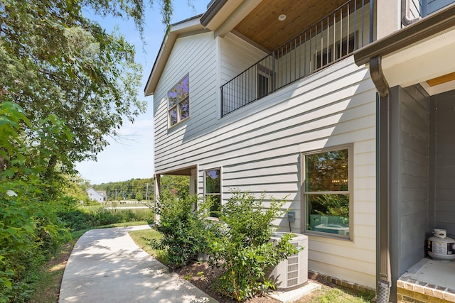 view of home's exterior with a balcony and central air condition unit