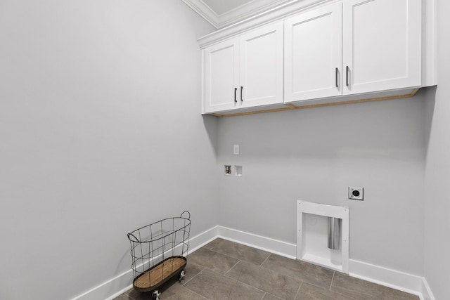 washroom featuring ornamental molding, hookup for a washing machine, baseboards, electric dryer hookup, and cabinet space
