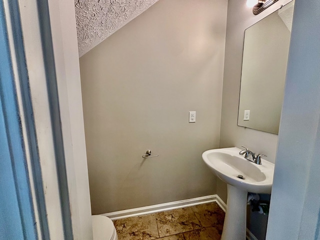 bathroom with tile patterned flooring and toilet