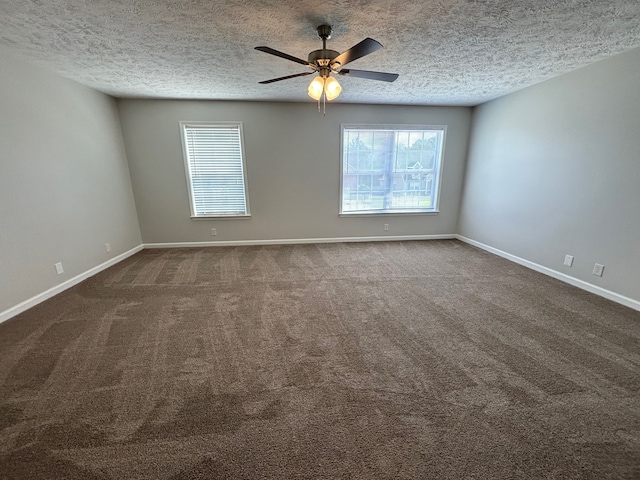 carpeted spare room with a textured ceiling and ceiling fan