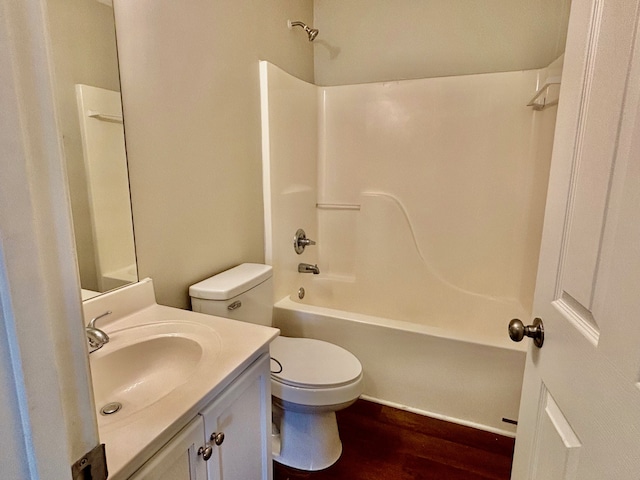 full bathroom with hardwood / wood-style flooring, bathing tub / shower combination, vanity, and toilet