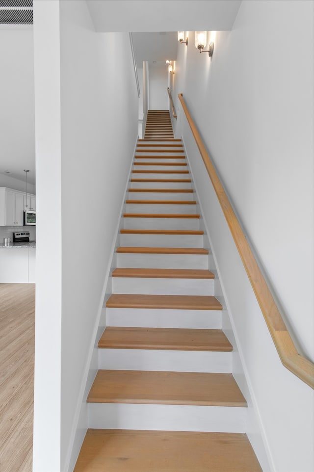 stairway featuring hardwood / wood-style floors