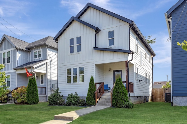 view of front of home featuring a front yard and central air condition unit