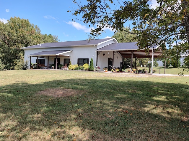 rear view of property with a yard