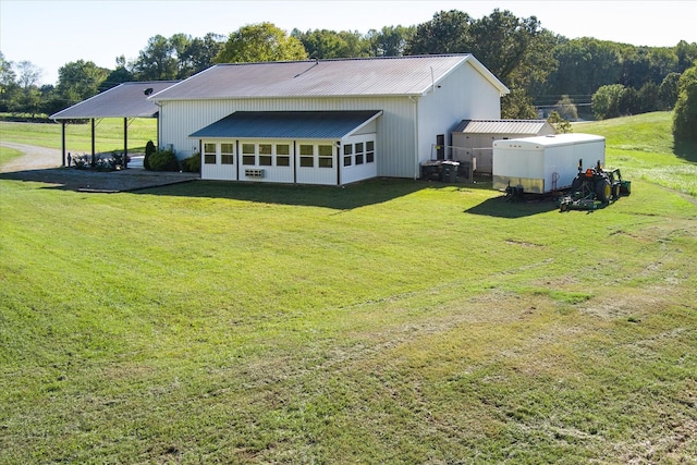 3075 Bennett Rd, Cookeville, TN 38506 - back of property featuring a metal roof, a yard, a carport, and a sunroom