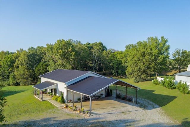 3075 Bennett Rd, Cookeville, TN 38506 - view of front of home featuring gravel driveway, a front yard, a carport, and a metal roof