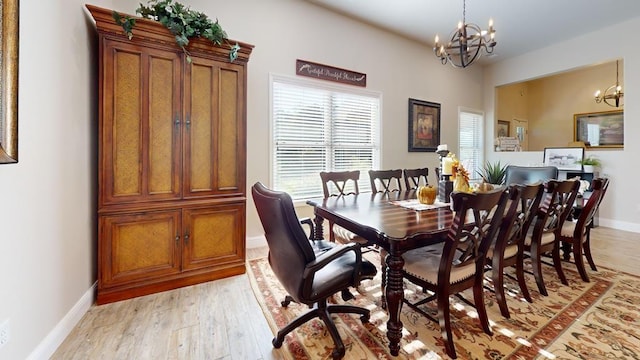 dining space with a notable chandelier and light wood-type flooring