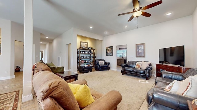 living room featuring ceiling fan and light hardwood / wood-style flooring